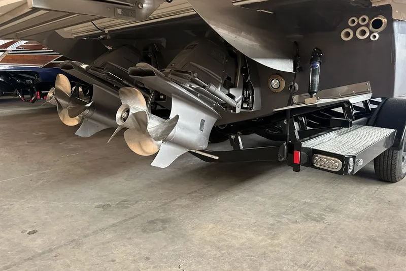 Slide: The Image of 2023 Regal LS36 boat with dual propellers in a garage setting. - 23