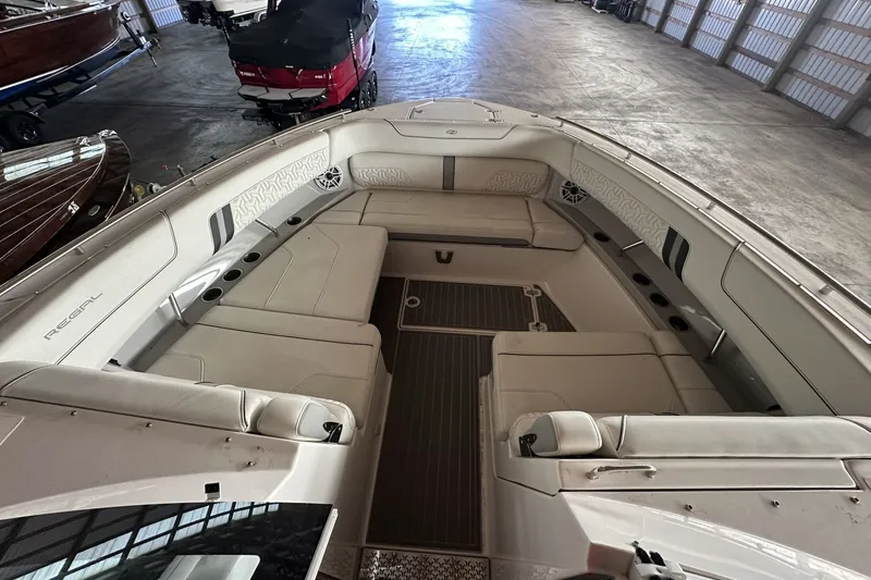 Slide: The Image of 2023 Regal LS36 boat interior with spacious seating in a storage facility. - 19