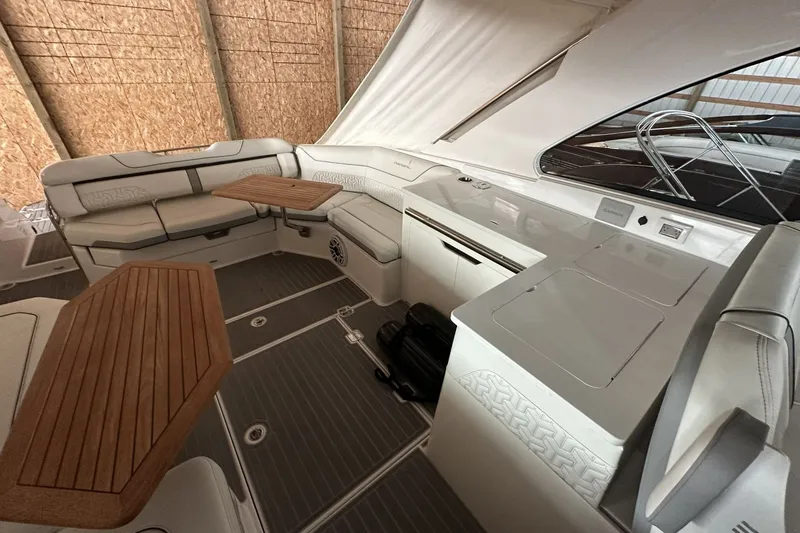 Slide: The Image of Luxurious interior of 2023 Regal LS36 boat with elegant seating and wooden tables. - 9
