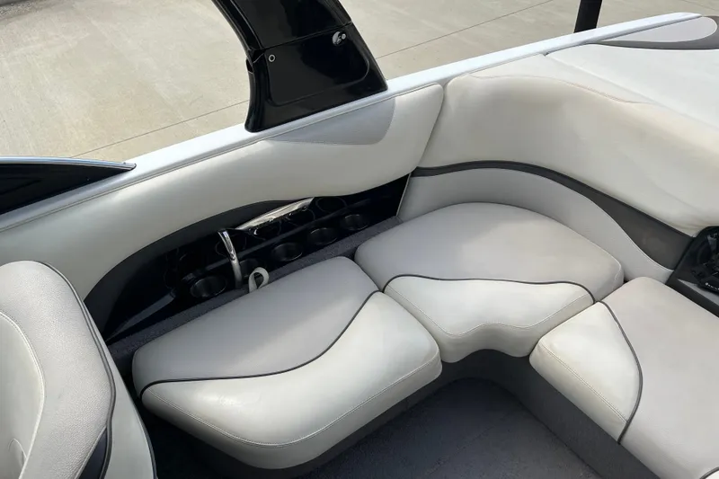 Slide: The Image of 2008 Malibu Wakesetter VLX interior with white cushioned seating and cup holders. - 16