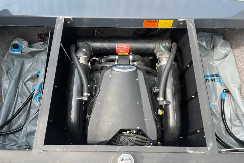 Slide: The Image of Engine compartment of a 2008 Malibu Wakesetter VLX boat, showcasing detailed components. - 17