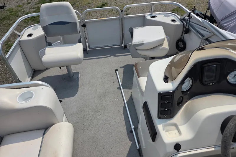 Slide: The Image of 2007 Quest mini pontoon boat interior with seating and control panel. - 5