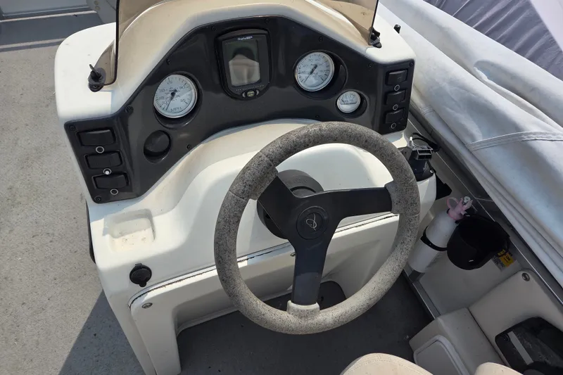 Slide: The Image of Steering console of a 2007 Quest mini pontoon boat with gauges and controls. - 6