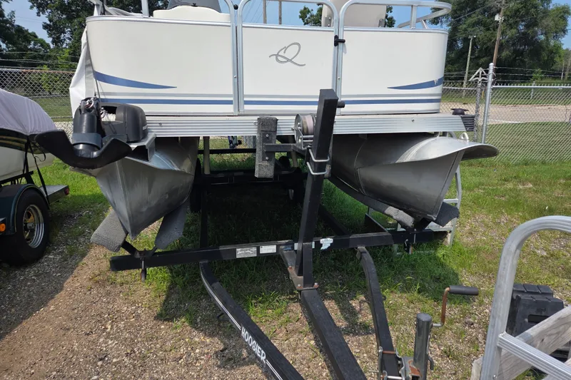 The Image of 2007 Quest mini pontoon boat on trailer, parked on grass near a fence. - 1