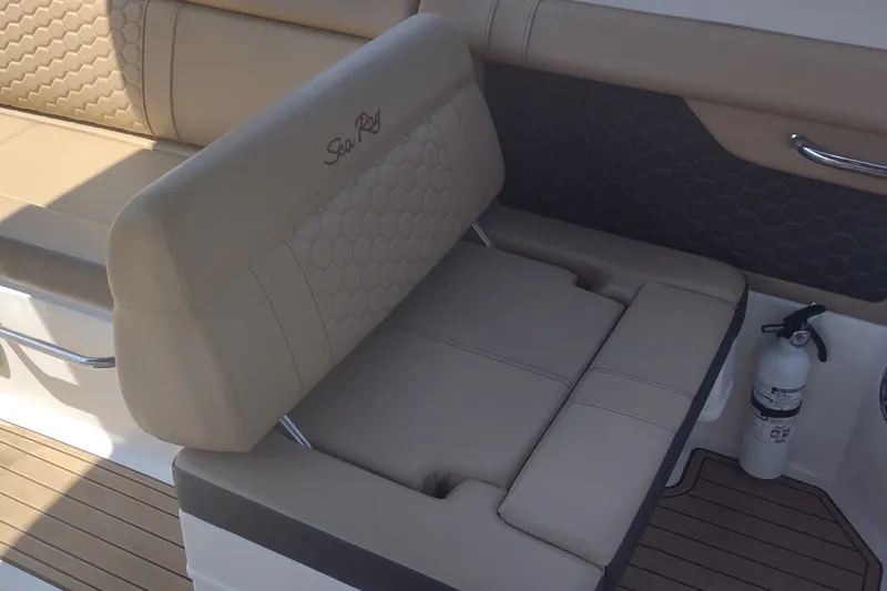 Slide: The Image of 2023 Sea Ray SDX 270 boat interior with beige seating and fire extinguisher. - 20