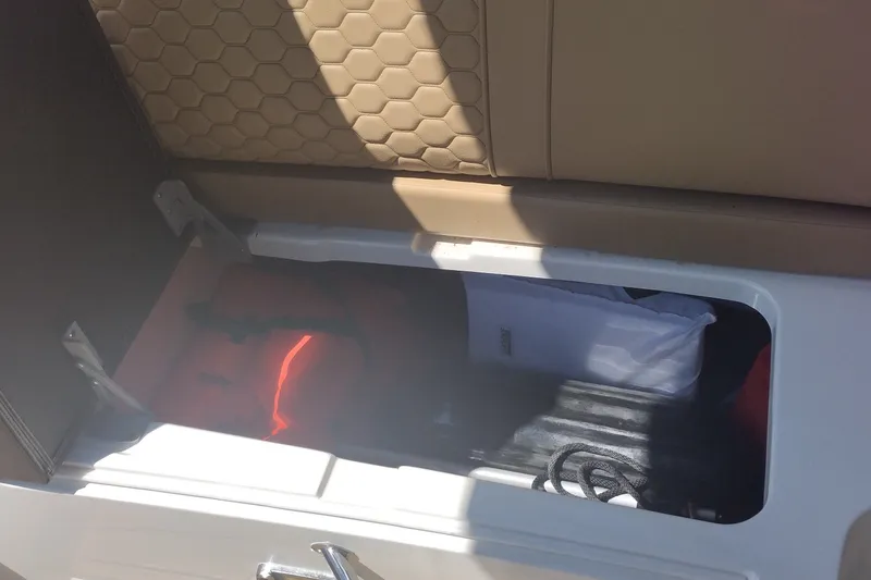 Slide: The Image of Storage compartment in 2023 Sea Ray SDX 270 boat, featuring life jackets and accessories. - 33