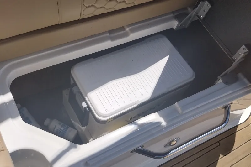 Slide: The Image of Storage compartment with cooler on 2023 Sea Ray SDX 270 boat. - 32