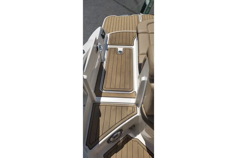 Slide: The Image of 2023 Sea Ray SDX 270 boat deck with tan and white detailing. - 55