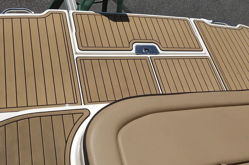 Slide: The Image of 2023 Sea Ray SDX 270 boat deck with tan and brown marine flooring. - 54