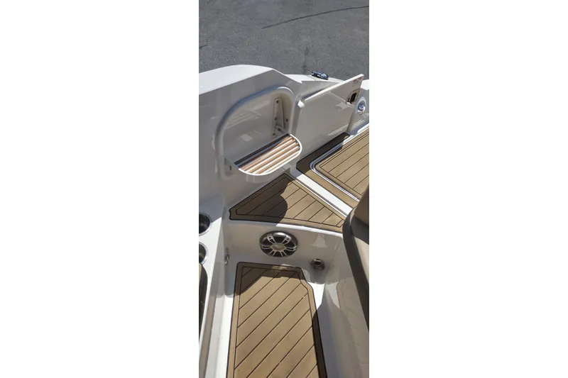 Slide: The Image of 2023 Sea Ray SDX 270 boat interior with teak flooring and seating area. - 56