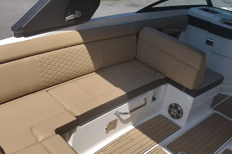 Slide: The Image of 2023 Sea Ray SDX 270 boat interior with tan seating and hexagonal pattern design. - 15