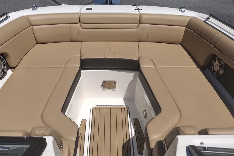 Slide: The Image of 2023 Sea Ray SDX 270 boat interior with tan seating and wood flooring. - 21