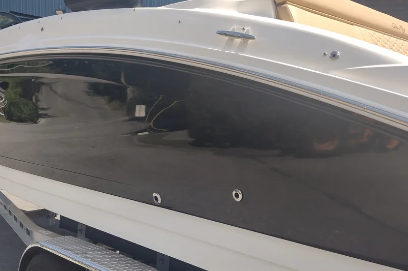 Slide: The Image of 2023 Sea Ray SDX 270 boat side view, featuring sleek black and white design. - 9