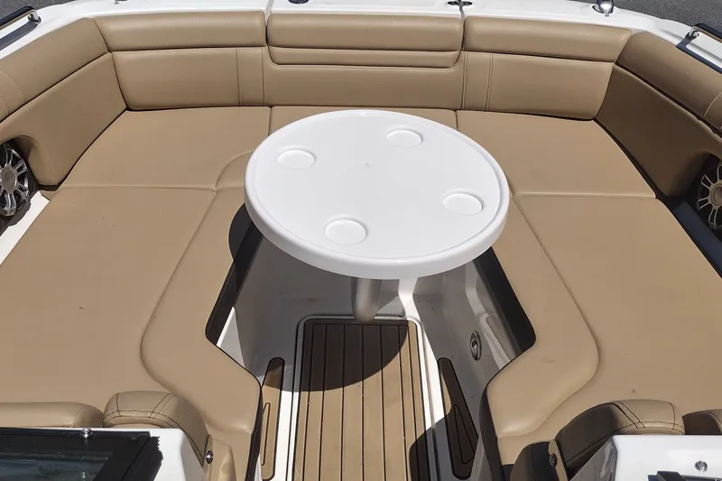 Slide: The Image of Interior of 2023 Sea Ray SDX 270 boat with beige seating and round table. - 44