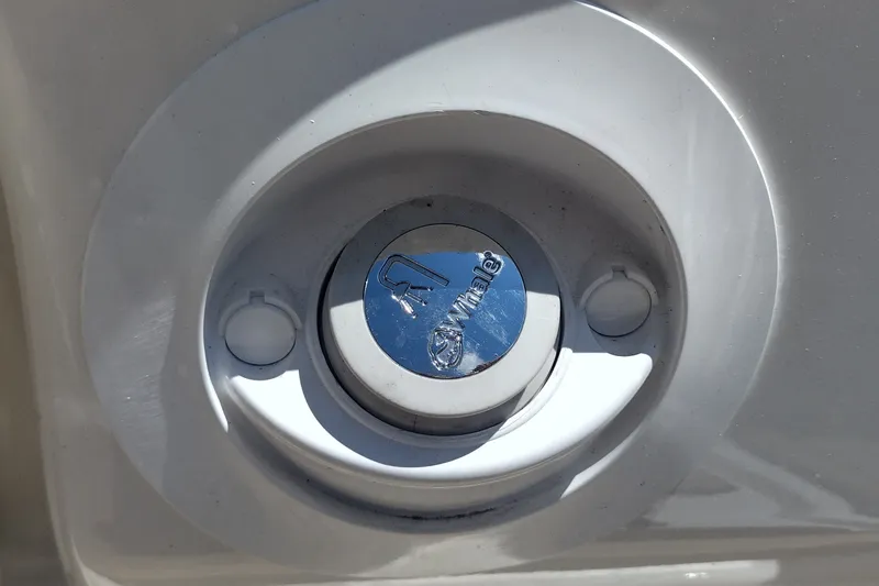 Slide: The Image of Fuel cap of 2023 Sea Ray SDX 270 boat, featuring Whale brand logo. - 42