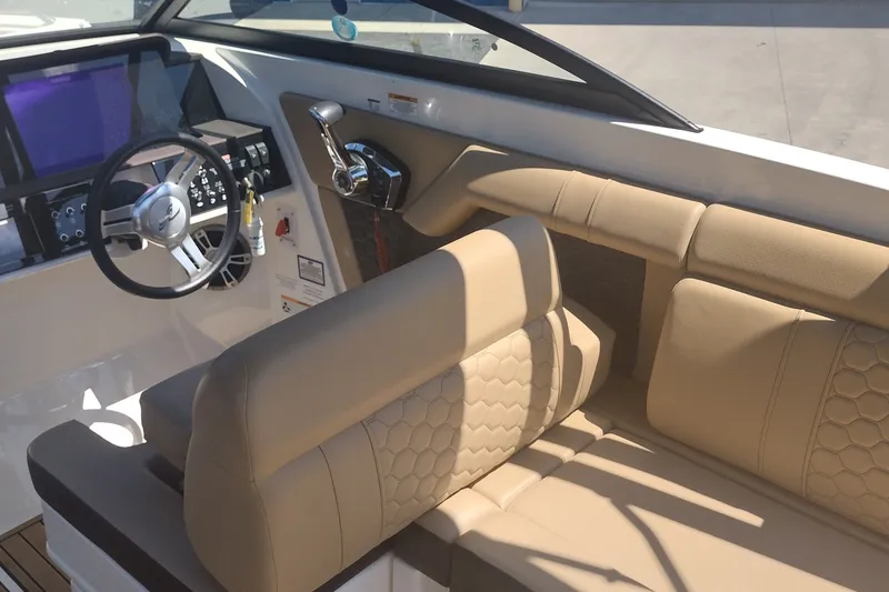 Slide: The Image of Interior of 2023 Sea Ray SDX 270 boat with beige seating and modern helm controls. - 17