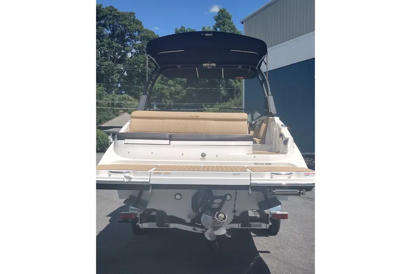 Slide: The Image of 2023 Sea Ray SDX 270 boat, rear view with seating and propeller, outdoors. - 6