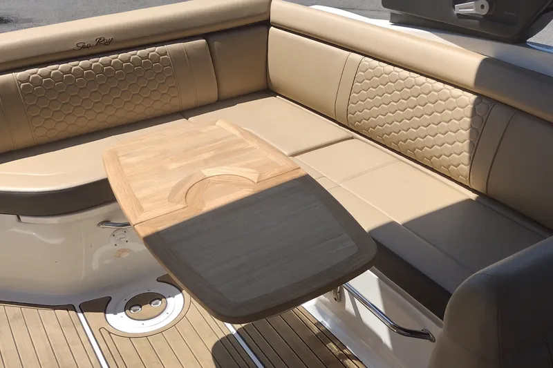 Slide: The Image of Luxurious seating area on 2023 Sea Ray SDX 270 boat with wooden table. - 45