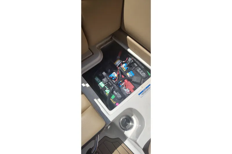 Slide: The Image of Battery compartment of 2023 Sea Ray SDX 270 boat, showcasing wiring and connections. - 38