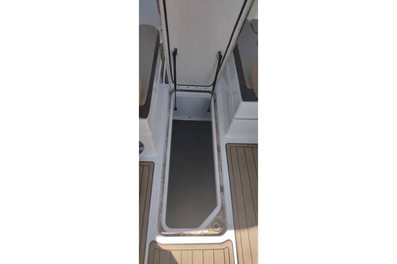 Slide: The Image of 2023 Sea Ray SDX 270 boat storage compartment with open hatch. - 31