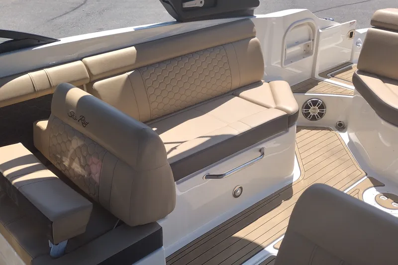 Slide: The Image of 2023 Sea Ray SDX 270 boat interior with tan leather seating and teak flooring. - 18