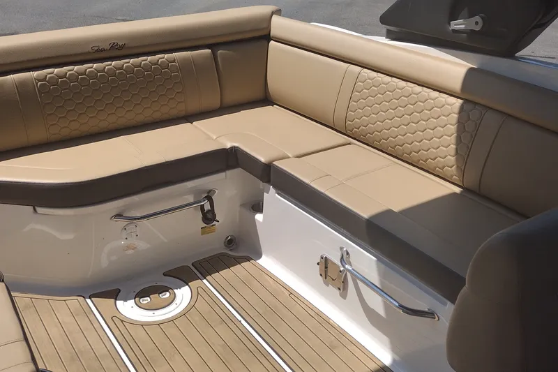 Slide: The Image of 2023 Sea Ray SDX 270 boat interior with tan leather seating and hexagonal stitching. - 19