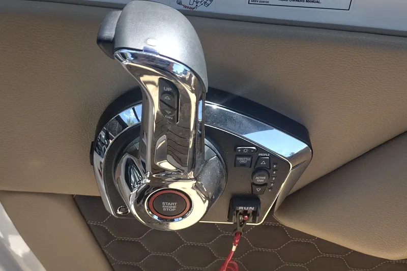 Slide: The Image of Throttle control panel of 2023 Sea Ray SDX 270 boat, featuring start/stop button. - 28