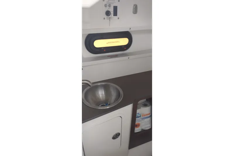 Slide: The Image of 2023 Sea Ray SDX 270 interior with sink and storage compartment. - 50