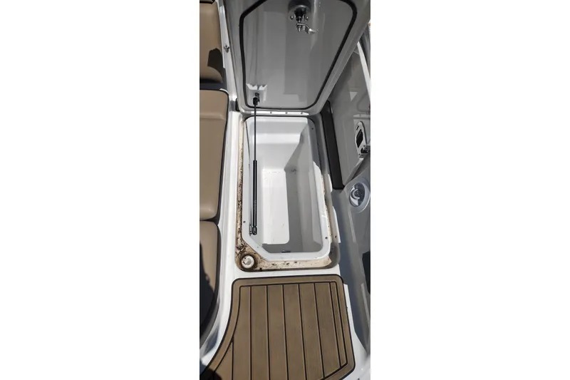 Slide: The Image of Open storage compartment on 2023 Sea Ray SDX 270 boat with teak flooring. - 41
