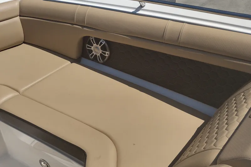 Slide: The Image of 2023 Sea Ray SDX 270 boat interior with beige seating and speaker detail. - 23
