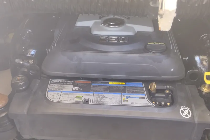 Slide: The Image of Engine compartment of 2023 Sea Ray SDX 270 with Mercury 350 engine label visible. - 35