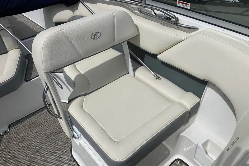 Slide: The Image of 2019 Cobalt 200S boat interior with white cushioned seating and sleek design. - 16