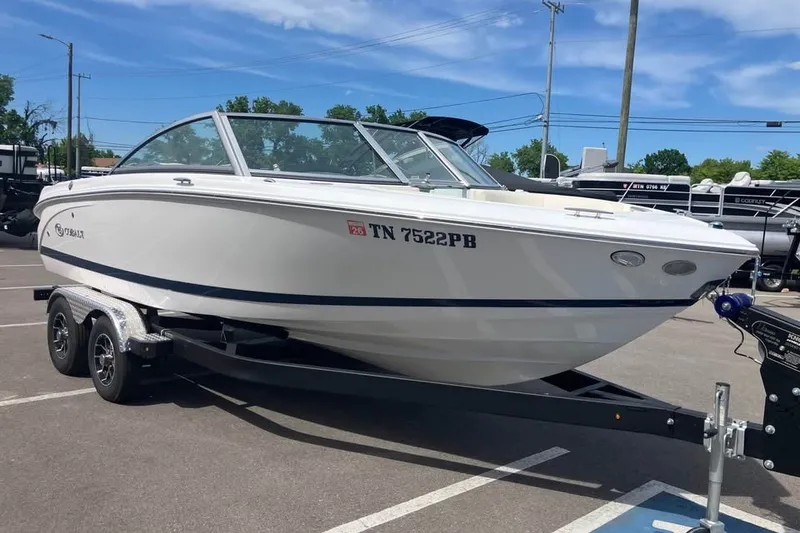 The Image of 2019 Cobalt 200S boat on trailer in parking lot, clear sky background. - 1