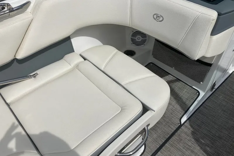 Slide: The Image of 2019 Cobalt 200S boat interior with white cushioned seating and speaker detail. - 14