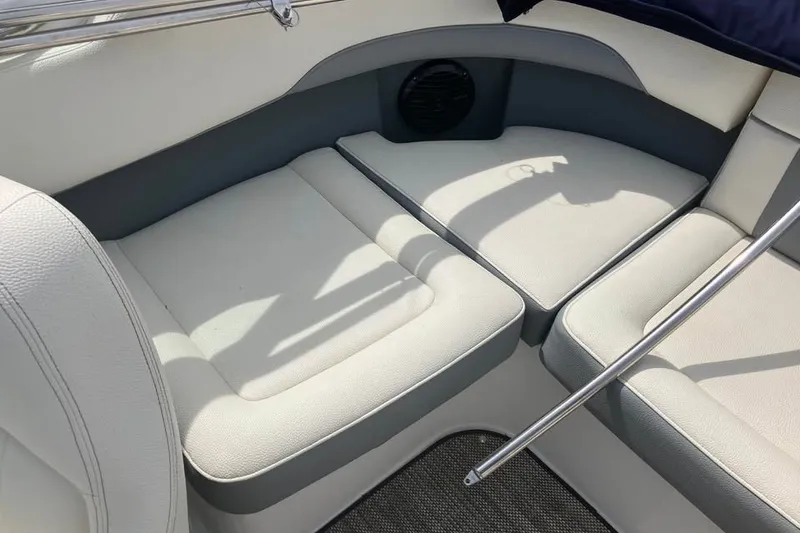 Slide: The Image of Interior seating of a 2019 Cobalt 200S boat, featuring white and gray upholstery. - 15
