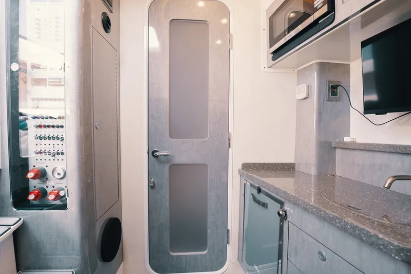 Slide: The Image of Interior of 2018 HCB 53 Suenos yacht with modern kitchen and control panel. - 27
