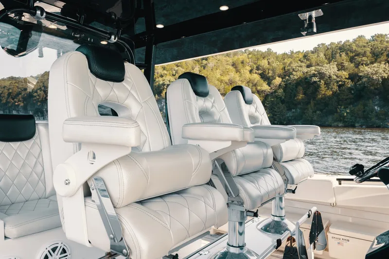 Slide: The Image of Luxurious seating on 2018 HCB 53 Suenos boat, featuring plush white leather chairs. - 48