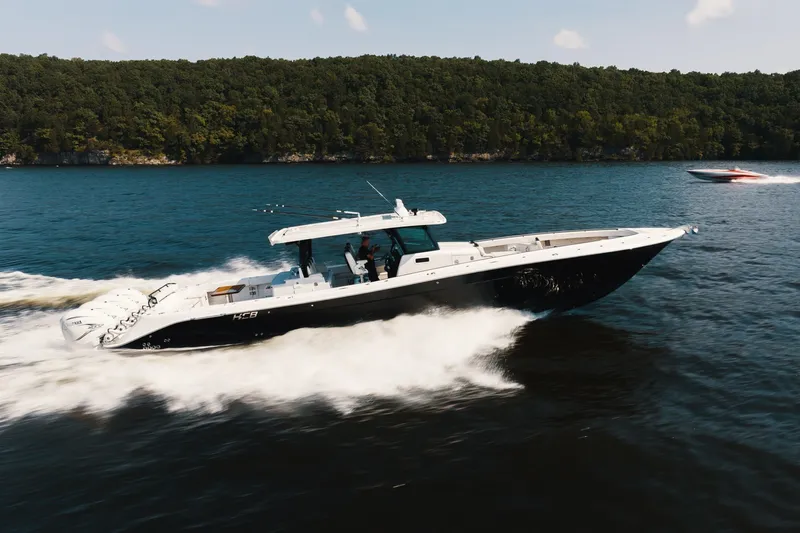 Slide: The Image of 2018 HCB 53 Suenos boat cruising on a lake with forested shoreline. - 60