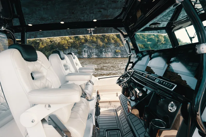 Slide: The Image of Luxurious interior of 2018 HCB 53 Suenos boat with plush seating and modern dashboard. - 22