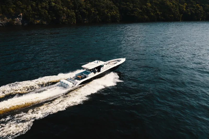 Slide: The Image of Aerial view of 2018 HCB 53 Suenos boat cruising on a scenic lake. - 62