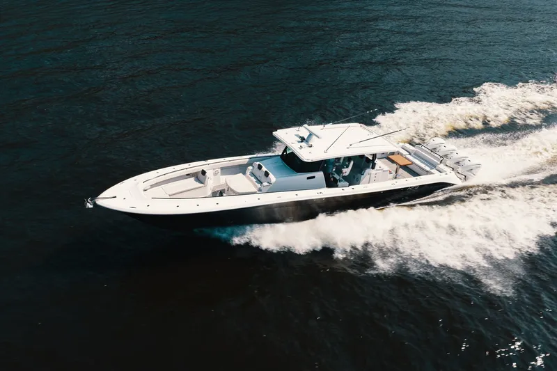 Slide: The Image of 2018 HCB 53 Suenos boat cruising on open water, creating a dynamic wake. - 56
