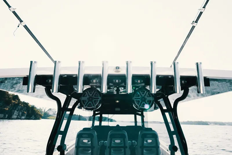 Slide: The Image of 2018 HCB 53 Suenos boat with fishing rod holders and speakers on a sunny day. - 20
