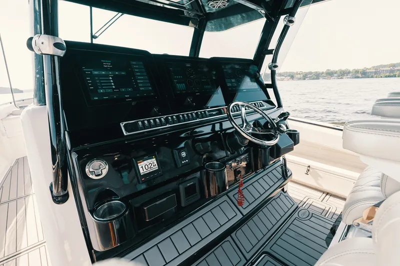 Slide: The Image of Helm of 2018 HCB 53 Suenos boat with advanced navigation controls and steering wheel. - 49