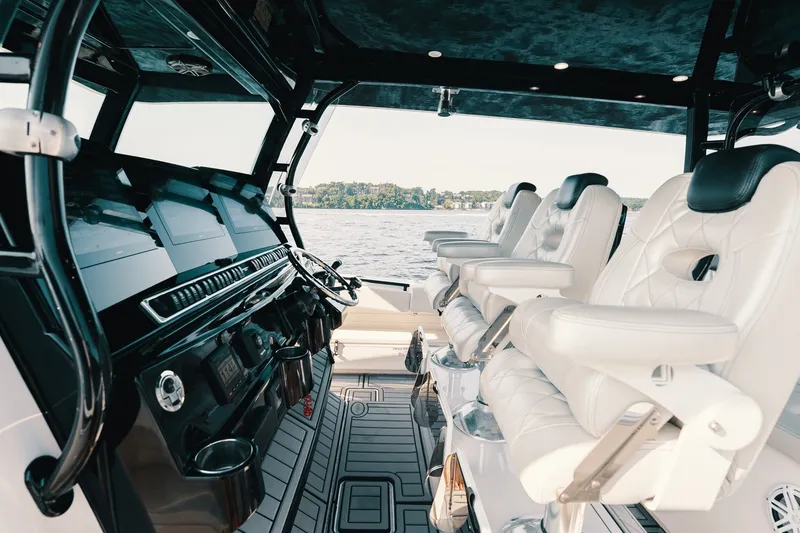 Slide: The Image of Interior of 2018 HCB 53 Suenos boat with luxurious white seating and sleek dashboard. - 42