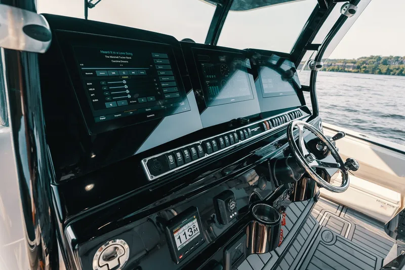 Slide: The Image of Helm of 2018 HCB 53 Suenos boat with advanced navigation displays and steering wheel. - 43
