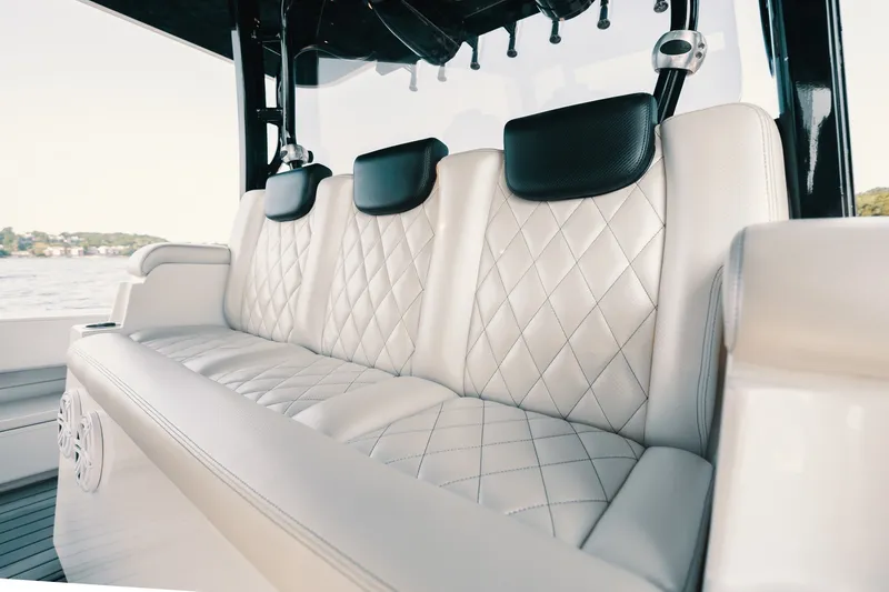 Slide: The Image of Luxurious white leather seating on 2018 HCB 53 Suenos boat, featuring diamond stitching and black headrests. - 40