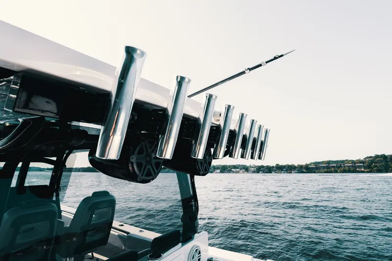 Slide: The Image of 2018 HCB 53 Suenos boat with rod holders on a calm lake. - 52