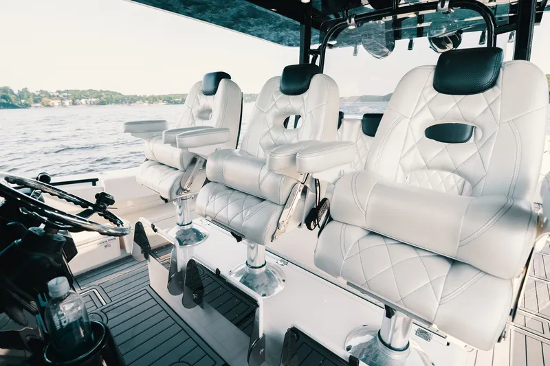 Slide: The Image of Luxurious white seating on 2018 HCB 53 Suenos boat, overlooking serene waters. - 41