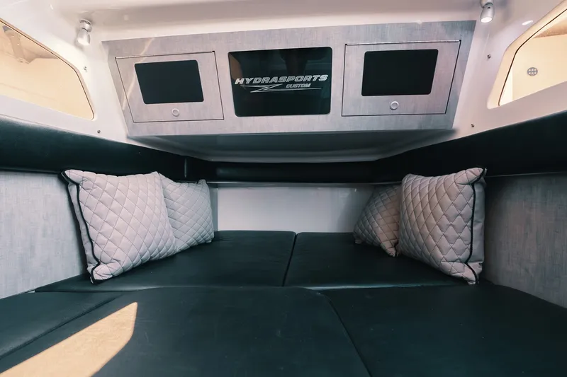 Slide: The Image of Interior cabin of 2018 HCB 53 Suenos boat with cushioned seating and pillows. - 25