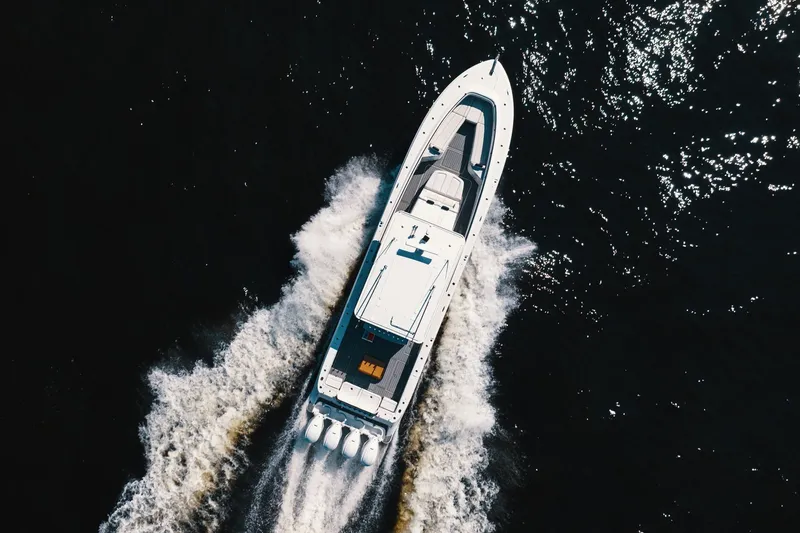 Slide: The Image of Aerial view of 2018 HCB 53 Suenos yacht cruising on dark water. - 61